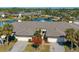 Aerial view of the property showcasing the landscaping, pond, and proximity to the water at 3663 Muirfield Dr # 4B, Sarasota, FL 34238