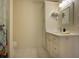 Well-lit bathroom featuring tile floors, updated vanity, and shower with colorful curtain at 3663 Muirfield Dr # 4B, Sarasota, FL 34238