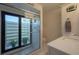 Modern bathroom with a glass-enclosed shower that leads to an outdoor sanctuary at 3663 Muirfield Dr # 4B, Sarasota, FL 34238