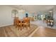 Open dining area adjacent to the living room with a full view of the water at 3663 Muirfield Dr # 4B, Sarasota, FL 34238