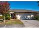 Well-maintained home with a two-car garage, manicured lawn, and beautiful landscaping at 3663 Muirfield Dr # 4B, Sarasota, FL 34238