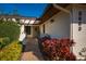 Charming front entrance with a stone pathway, garden beds, and attractive landscaping at 3663 Muirfield Dr # 4B, Sarasota, FL 34238