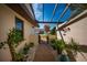 Inviting front yard with plants along walkway up to gated courtyard at 3663 Muirfield Dr # 4B, Sarasota, FL 34238