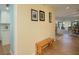 Hallway with wood floors and a view into the living room and dining area at 3663 Muirfield Dr # 4B, Sarasota, FL 34238