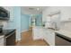 Well-lit kitchen with eat-in nook, white cabinets, and stainless steel appliances at 3663 Muirfield Dr # 4B, Sarasota, FL 34238