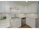 Bright kitchen with stainless steel dishwasher and ample cabinet space at 3663 Muirfield Dr # 4B, Sarasota, FL 34238