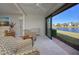 Inviting living room with sliding doors to patio and peaceful water view at 3663 Muirfield Dr # 4B, Sarasota, FL 34238