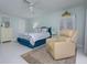 Relaxing main bedroom with calm hues and a comfortable sitting area at 3663 Muirfield Dr # 4B, Sarasota, FL 34238