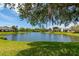 Scenic water view showing waterfront homes and a picturesque pond, perfect for relaxed living at 3663 Muirfield Dr # 4B, Sarasota, FL 34238