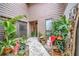 Private courtyard with tropical plants and a stone path at 3844 Wilshire W Cir # 20, Sarasota, FL 34238