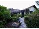 Enclosed pool area with tropical landscaping and stone path at 3947 Country View Dr, Sarasota, FL 34233