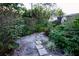 Stepping stones create a pathway through a tranquil garden at 3947 Country View Dr, Sarasota, FL 34233