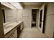 Bathroom with double vanity and access to other rooms at 3947 Country View Dr, Sarasota, FL 34233