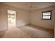 Spacious bedroom with carpeting and views into the kitchen at 3947 Country View Dr, Sarasota, FL 34233