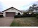 Single-story house with brown garage door and manicured lawn at 3947 Country View Dr, Sarasota, FL 34233