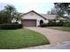Single-story house with brown garage door and manicured lawn at 3947 Country View Dr, Sarasota, FL 34233