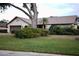 Single-story house with brown garage door and lush landscaping at 3947 Country View Dr, Sarasota, FL 34233