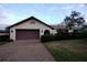 Single story home with brown garage door and manicured lawn at 3947 Country View Dr, Sarasota, FL 34233