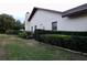 Exterior view of the home's side, showcasing well-maintained landscaping at 3947 Country View Dr, Sarasota, FL 34233