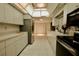 Long kitchen with ample counter space and stainless steel appliances at 3947 Country View Dr, Sarasota, FL 34233