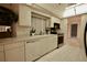 Kitchen features white cabinets, stainless steel appliances, and tile floors at 3947 Country View Dr, Sarasota, FL 34233