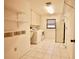Laundry room with washer, dryer, and storage shelving at 3947 Country View Dr, Sarasota, FL 34233