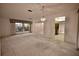 Spacious living room with large windows and carpet flooring at 3947 Country View Dr, Sarasota, FL 34233