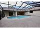 Inviting kidney-shaped pool with a screened enclosure at 3947 Country View Dr, Sarasota, FL 34233