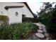 Landscaped side yard with stone path and wrought iron fence at 3947 Country View Dr, Sarasota, FL 34233