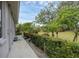 Landscaped backyard with lush greenery and a walkway at 404 Bayside Ln, Nokomis, FL 34275