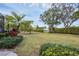Large backyard with mature trees and lush landscaping at 404 Bayside Ln, Nokomis, FL 34275