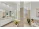 Elegant bathroom with double vanity, large shower, and soaking tub at 404 Bayside Ln, Nokomis, FL 34275