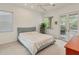 Serene bedroom with a queen-size bed and access to a private balcony at 404 Bayside Ln, Nokomis, FL 34275
