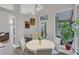 Bright dining nook with round table and chairs near a door to a lanai at 404 Bayside Ln, Nokomis, FL 34275