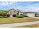Single-story home with a metal roof, and landscaped lawn at 404 Bayside Ln, Nokomis, FL 34275