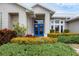 Front entryway of single-story home with blue door at 404 Bayside Ln, Nokomis, FL 34275