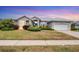 Single-story home with a metal roof, and landscaped lawn at 404 Bayside Ln, Nokomis, FL 34275