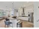 Updated kitchen featuring stainless steel appliances and a breakfast bar at 404 Bayside Ln, Nokomis, FL 34275