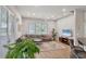 Bright living room with comfy sectional sofa, large window, and stylish decor at 404 Bayside Ln, Nokomis, FL 34275