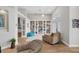 Bright living room with built-in shelving and hardwood floors at 404 Bayside Ln, Nokomis, FL 34275