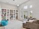 Spacious living area featuring built-in bookshelves and ample natural light at 404 Bayside Ln, Nokomis, FL 34275