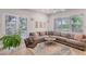Spacious living area featuring a sectional sofa and plenty of natural light at 404 Bayside Ln, Nokomis, FL 34275