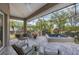 Relaxing screened patio with hot tub, seating, and outdoor kitchen at 404 Bayside Ln, Nokomis, FL 34275
