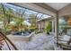 Screened patio with hot tub and seating area at 404 Bayside Ln, Nokomis, FL 34275