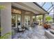 Covered patio with seating area and access to the home at 404 Bayside Ln, Nokomis, FL 34275