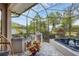 Outdoor kitchen and hot tub area on a screened patio at 404 Bayside Ln, Nokomis, FL 34275