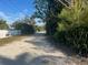 Residential street with a dirt road and trees at 4122 N Lockwood Ridge Rd, Sarasota, FL 34234