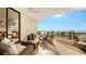 Relaxing balcony with ocean views and comfortable patio furniture at 415 L Ambiance Dr # C204, Longboat Key, FL 34228
