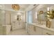 Luxury bathroom with double vanity, gold fixtures, and marble flooring at 415 L Ambiance Dr # C204, Longboat Key, FL 34228