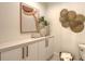 Modern bathroom with white cabinets, a freestanding tub, and gold fixtures at 415 L Ambiance Dr # C204, Longboat Key, FL 34228